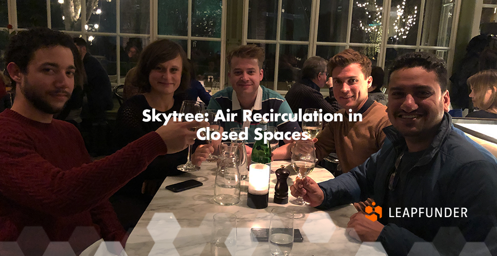 Five people having dinner at the table