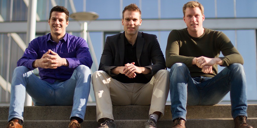 Three young men posing for a business photo