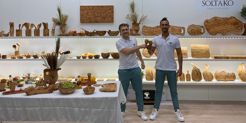 Two men posing with kitchen essentials made of premium wood