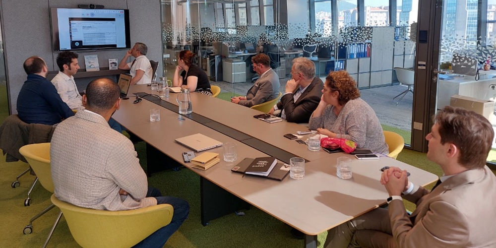 A group of people sitting around the table at a business meeting